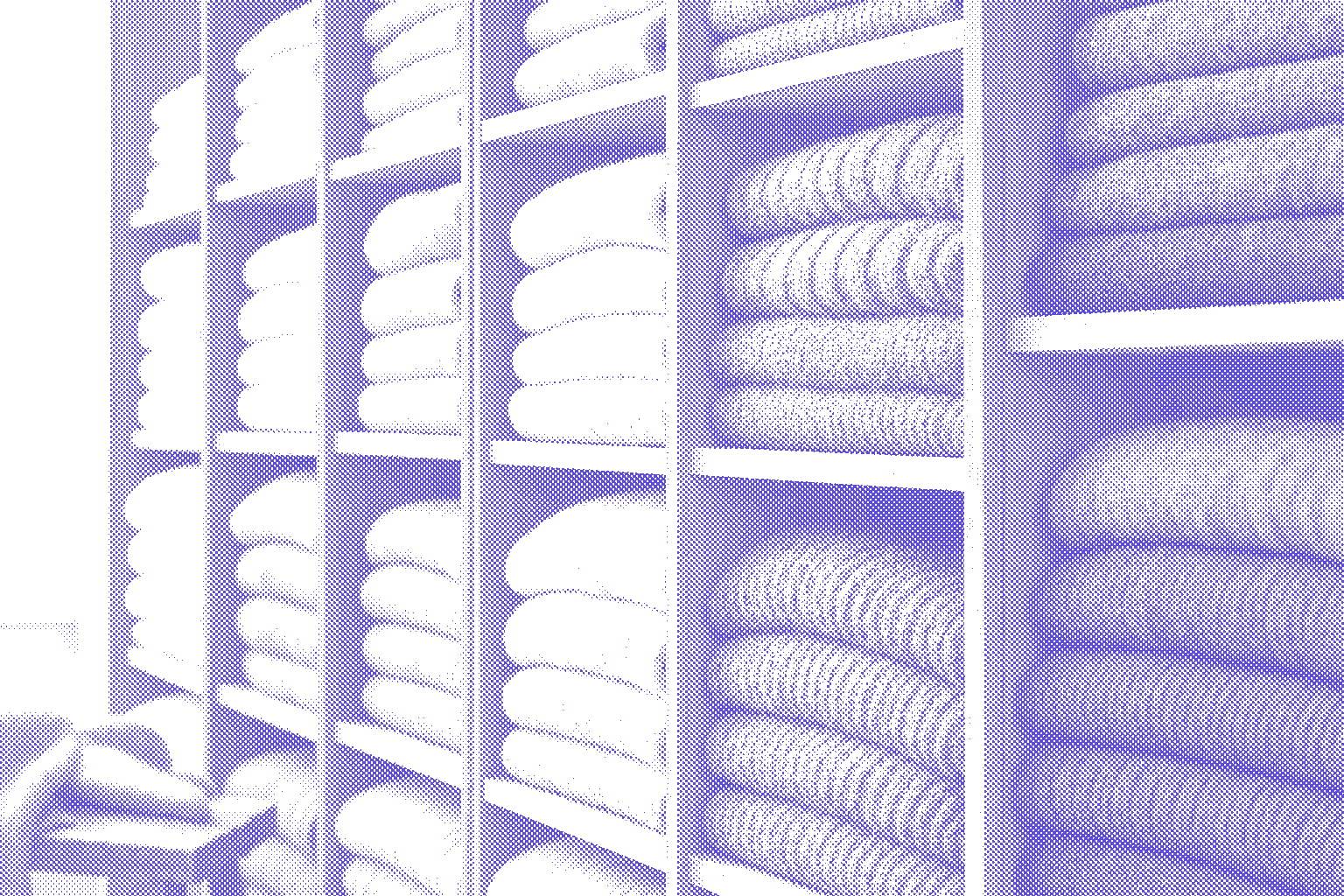 Shelves of folded knitwear in a color gradient from cream to blue